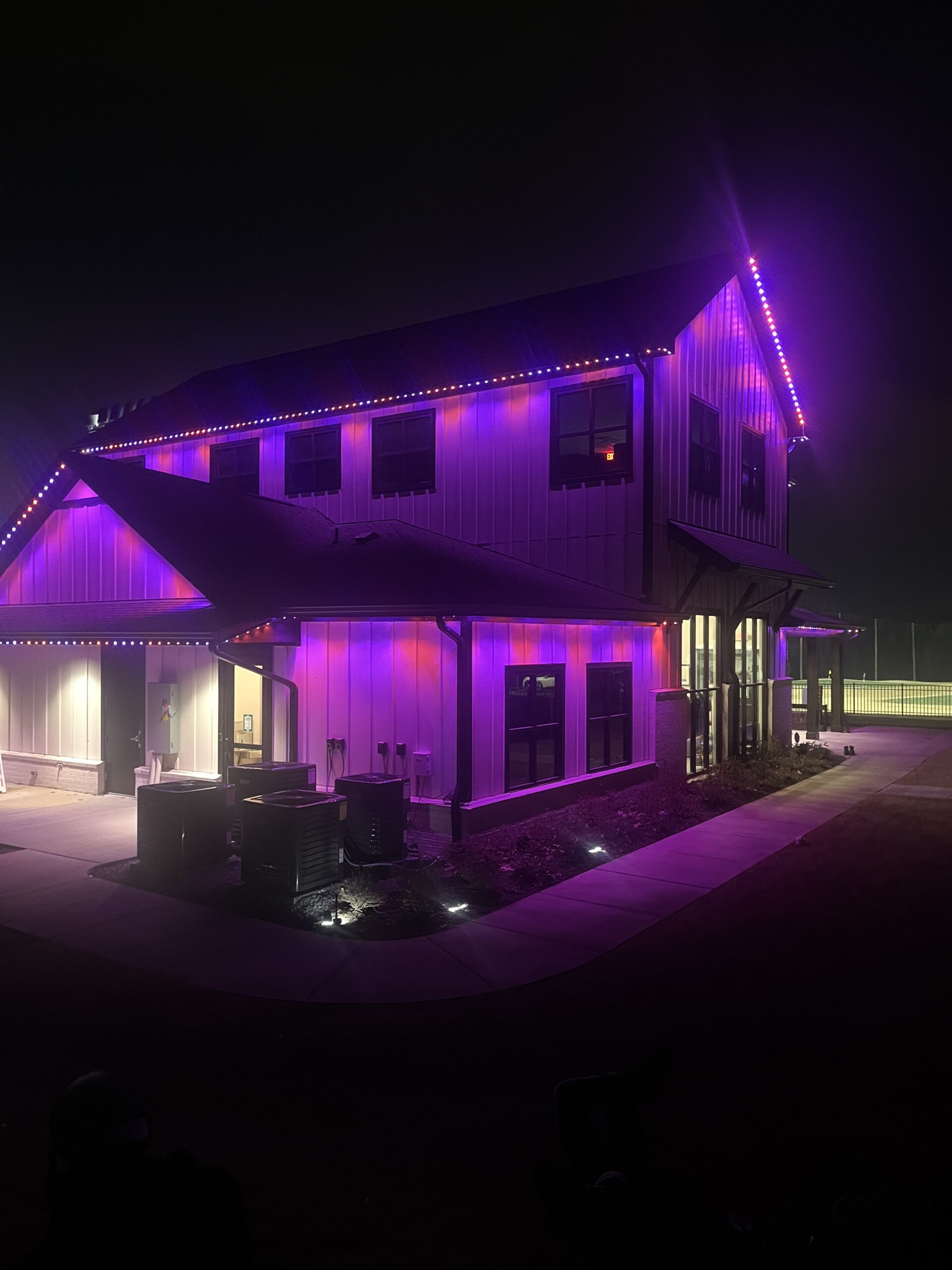 Clarksville Permanent Lighting team installing LED permanent lighting on a home exterior in Clarksville, TN.