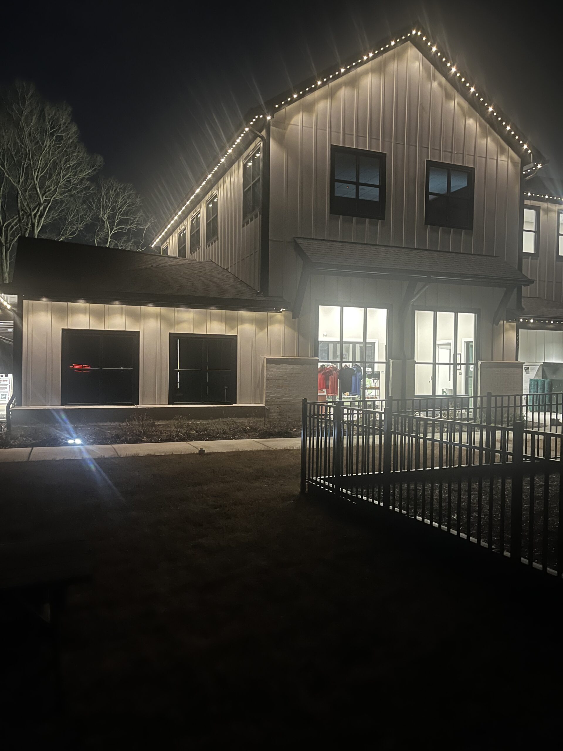 Clarksville Permanent Lighting team installing LED permanent lighting on a home exterior in Clarksville, TN.