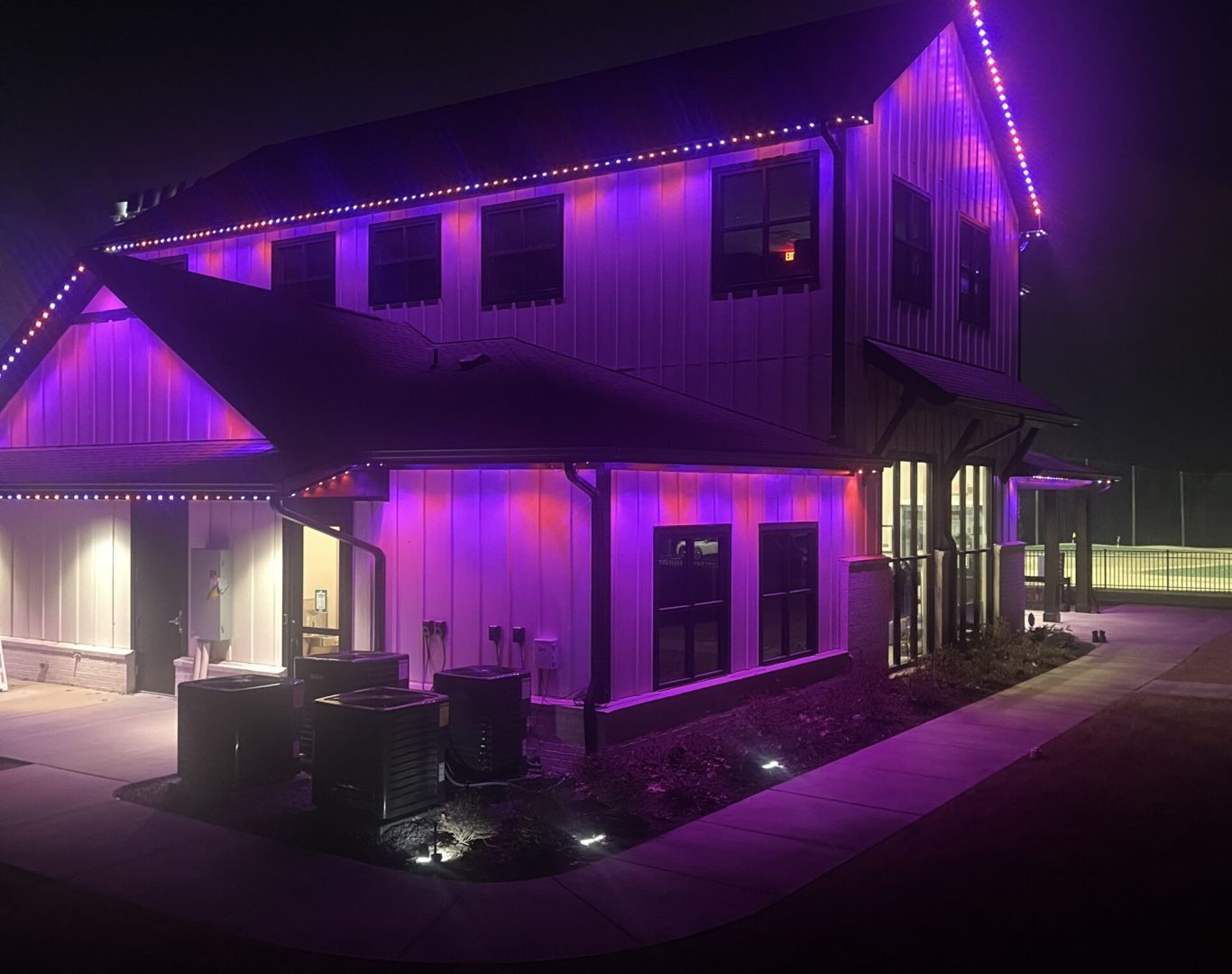 Clarksville Permanent Lighting team installing LED permanent lighting on a home exterior in Clarksville, TN.